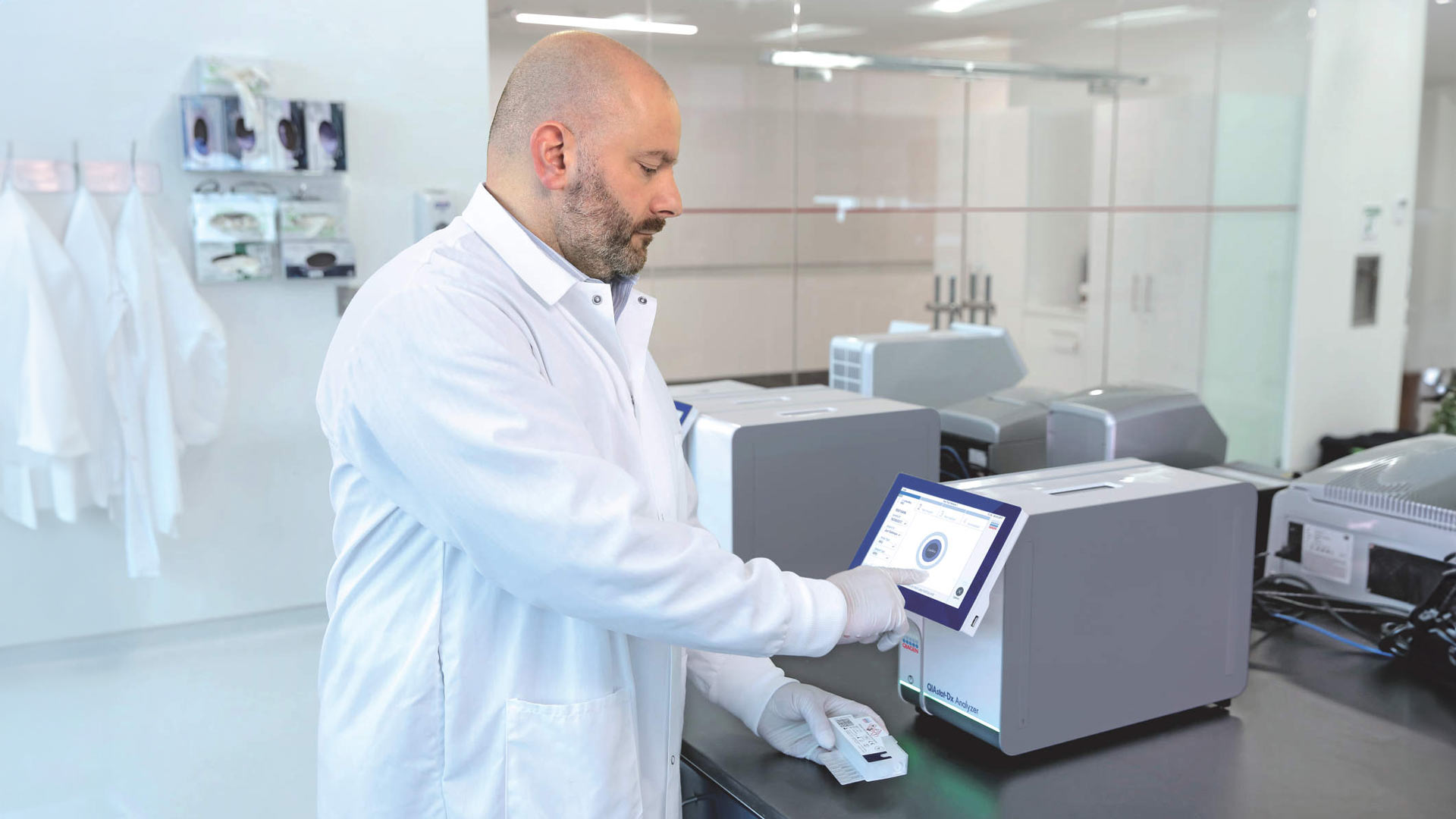 QIAstat-Dx, QIAstat-Dx analyzer, syndromic testing, instrument, cartridge, technician, man, lab tech, lab, laboratory